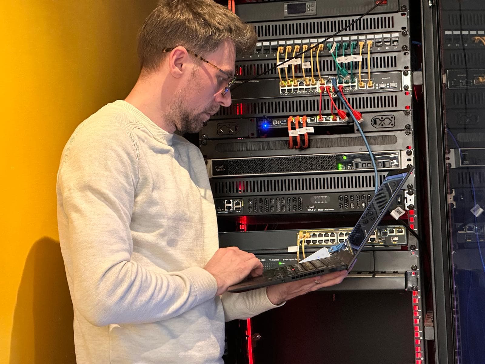 Mihail Pascal working on his enterprise home-lab rack in Galați